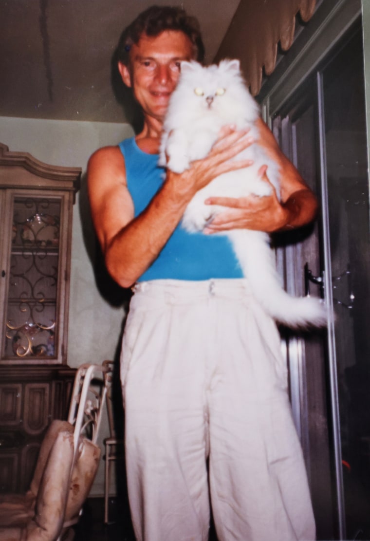 روبرت مالسبيري يحمل قطة بيضاء.